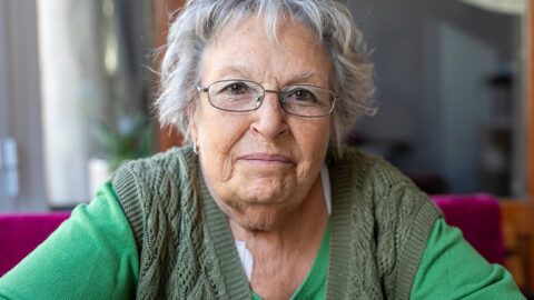 older woman faces the camera directly
