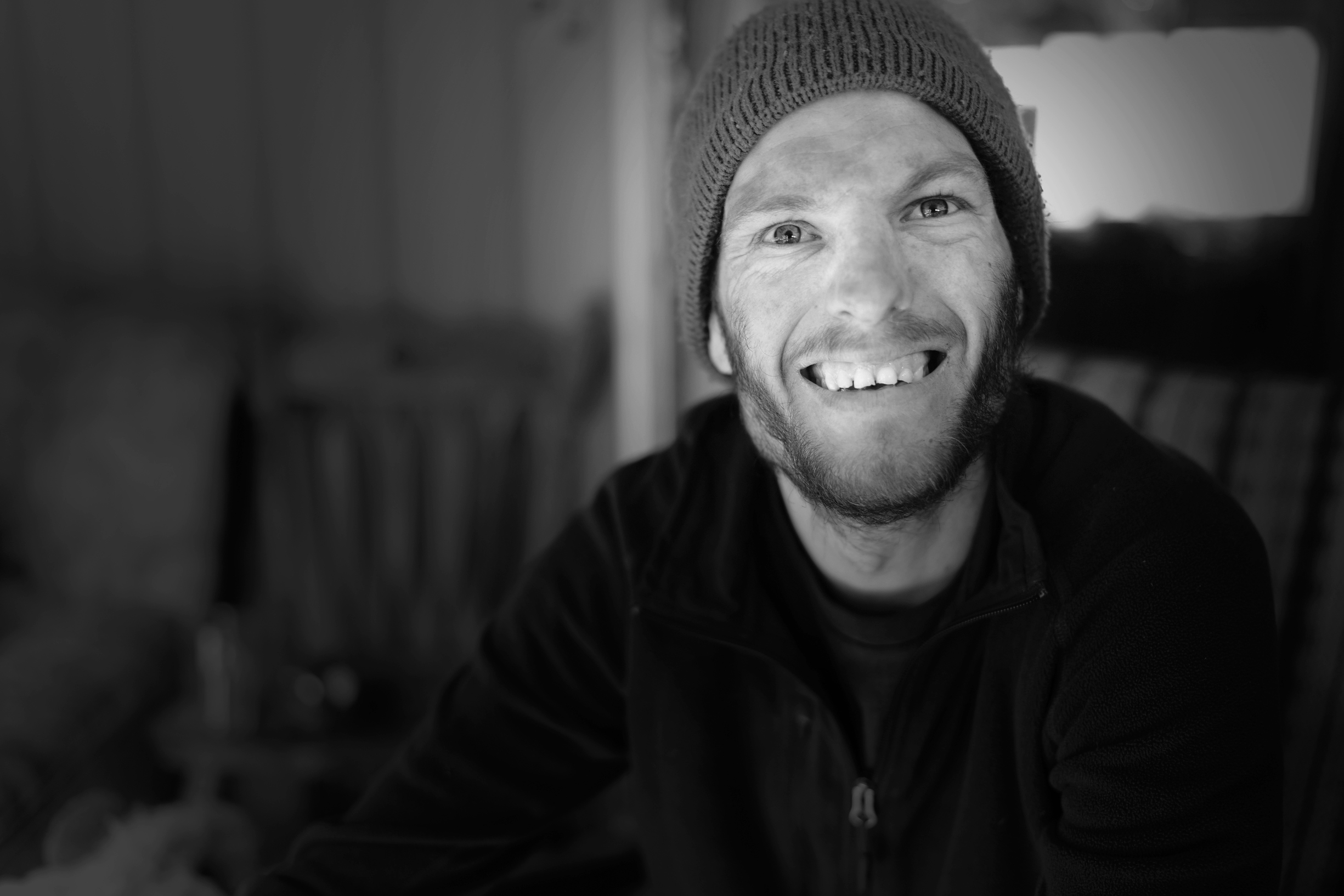 Person wearing a beanie smiling at the camera