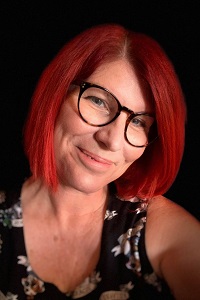 Photo of Samantha Connor smiling with bright red hair
