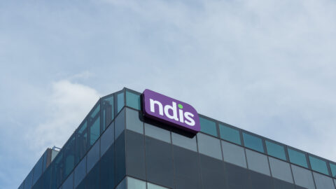 Top of an office building with NDIS sign on the corner.