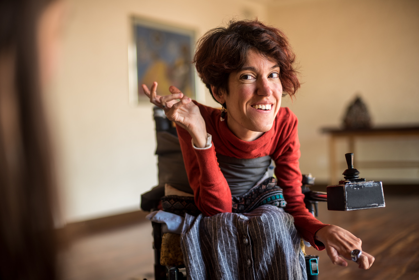 person smiling in a motorised wheelchair