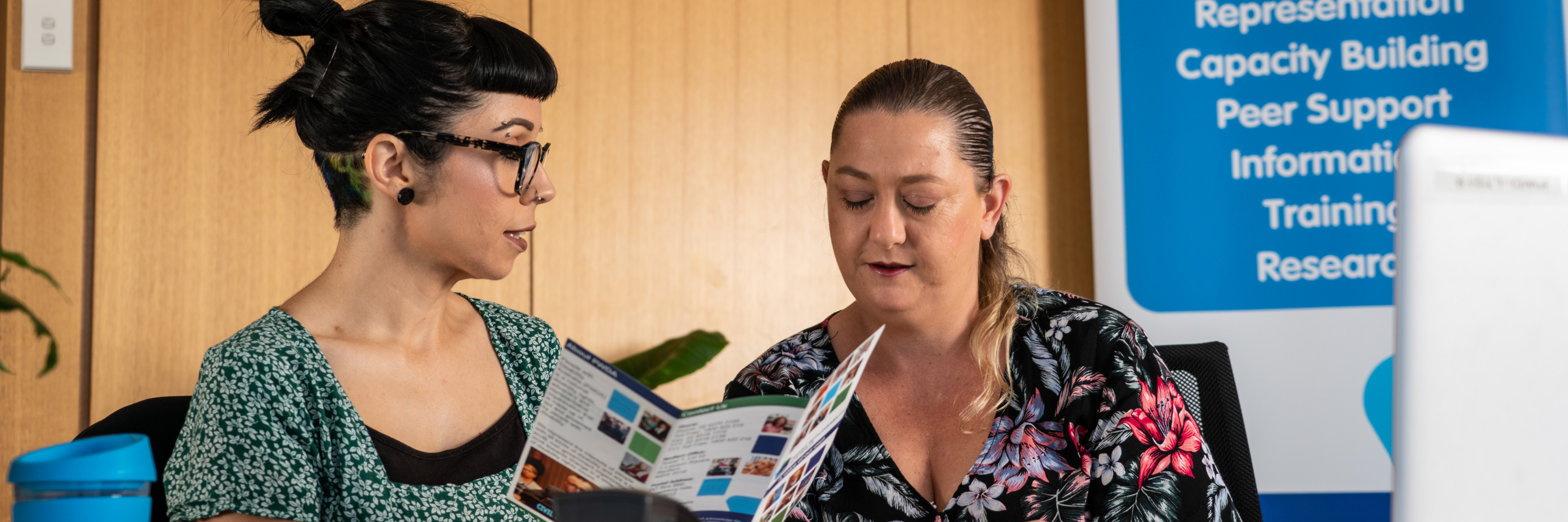 two people discussing a brochure