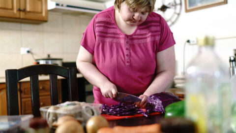 Woman chopping Red Cabbage in a Kitchen