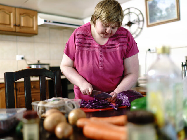 Woman chopping Red Cabbage in a Kitchen