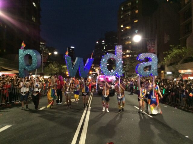 Marchers in the 2014 Sydney Mardi Gras Parade holding PWDA signs