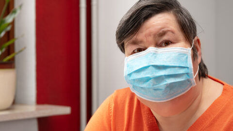 A woman wearing a surgical mask, covid-19