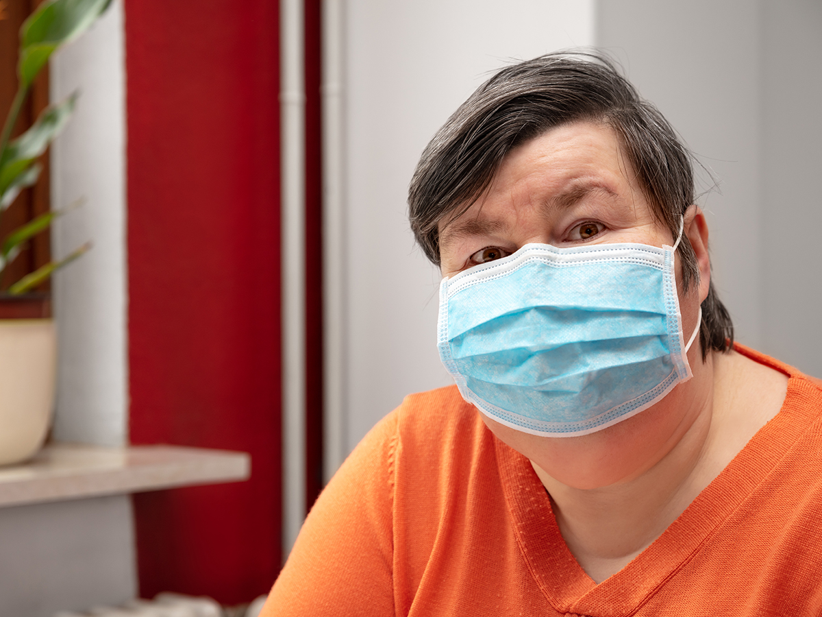 A woman wearing a surgical mask, covid-19