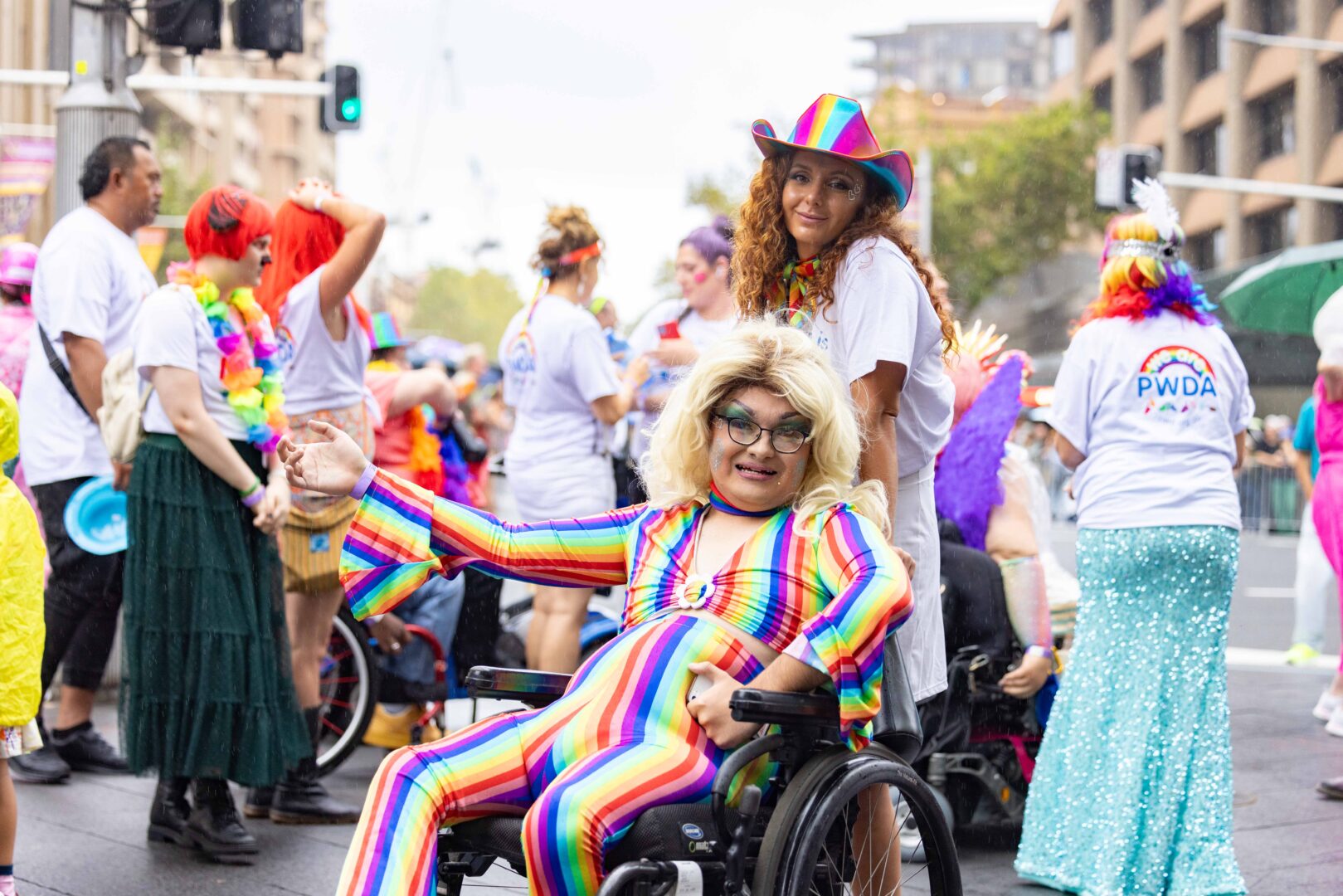 PWDA member at 2024 Mardi Gras wearing a rainbow jumpsuit