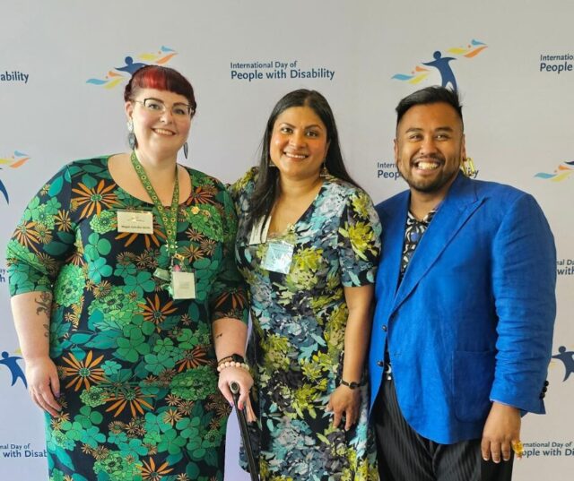 Deputy CEO Megan Spindler Smith, Sara Shams, a 2024 IDPWD Ambassador and MC from DSS morning tea and Senior Manager of Policy, Giancarlo De Vera standing in front of a background with IDPwD logos.