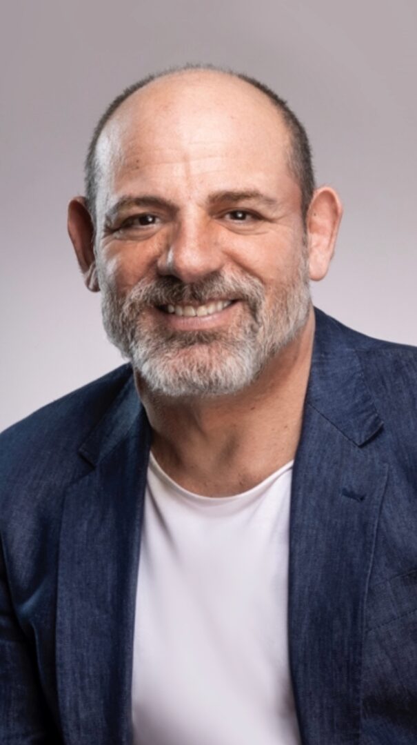 Headshot of Sebastian Zagarella wearing a white t-shirt and blue blazer. 