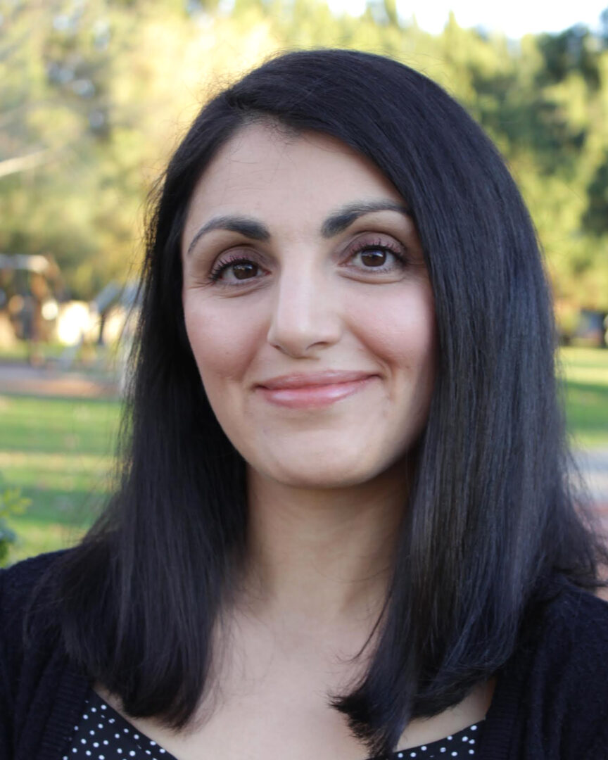 Headshot of Simone Tunbridge smiling at the camera. 