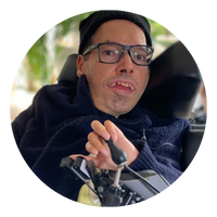 Dr George Taleporos Circle - People with Disability Australia Dr George Taleporos wearing glasses and a blue top