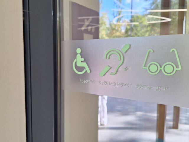 Featured Image size guide WordPress - People with Disability Australia Accessible entrance with disability symbols on glass door in sunlit building