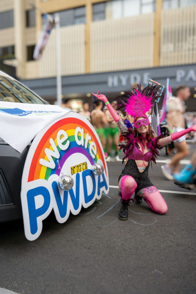 PWDA participant with Van and We Are PWDA logo at Mardi Gras 2026