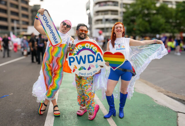 PWDA participants with signs at Mardi Gras 2026